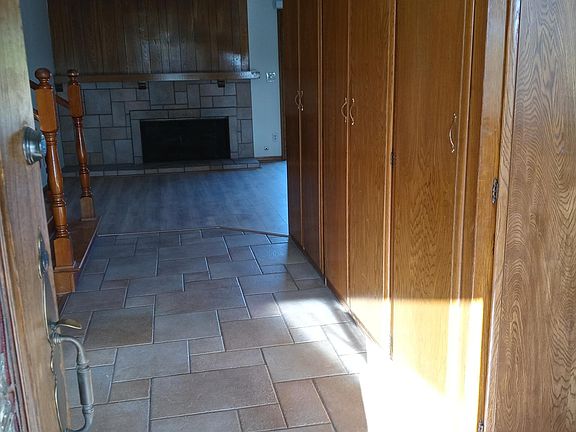 View walking into the home. Tile walkway to a lovely gas fireplace and open living area.