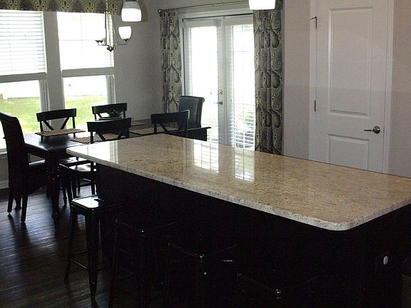 dining space opens to back yard patio. large kitchen island and pantry both with lots of storage.