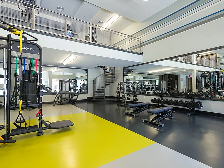 Well equipped fitness center featuring machines and free weights