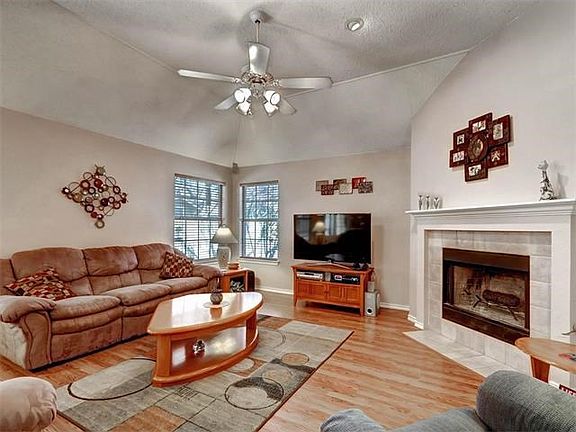 Kick back and relax and entertain in living room.  The fireplace can warm an evening and those great windows can allow natural light to shine in to brighten your days!!