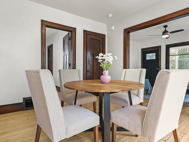 Cozy dining room; gorgeous hard woods and a stackable washer and dryer behind that door. Convenient!