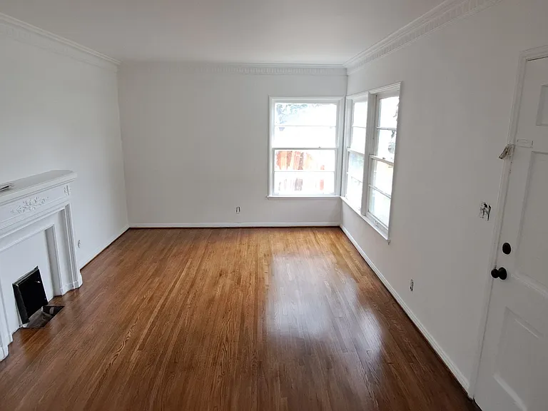 Living room with faux fire place heater, New hardwood floors oak, will have window ac unit with wifi access. Size is 12'x18' sq feet. 

Here is walk through video of the unit: