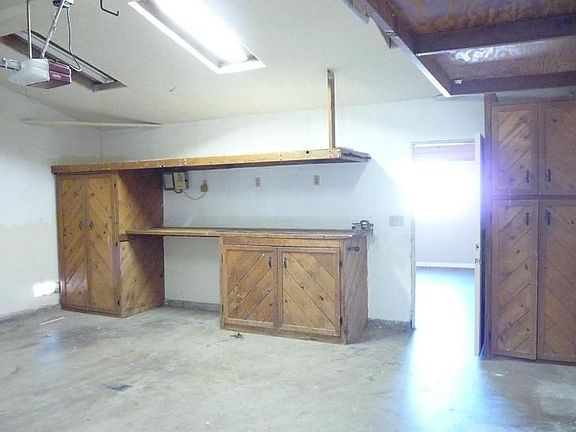 Large garage with workbench and shop lights already installed.