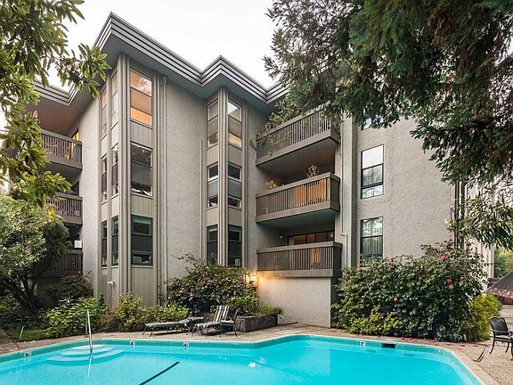 Common area grounds with a sparkling pool and lush landscaping