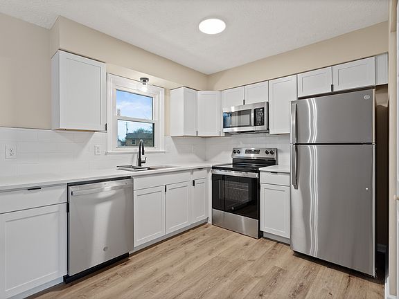 Quartz Countertops, Brand New Cabinets & Appliances
