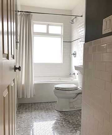 Remodeled Bathroom with White Subway Tiles and Mosaic Floor.