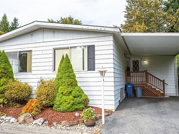Covered car port and additional parking to the left of home.