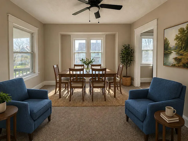 Dedicated dining area with a full-size table, ceiling fan, and multiple windows for everyday meals and gatherings.