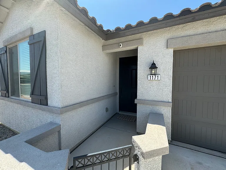 Private gated entryway with a covered front porch.