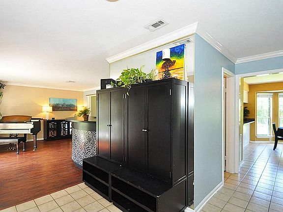 The entry has low maintenance tile floors with views into the breakfast area and spacious formal living room.