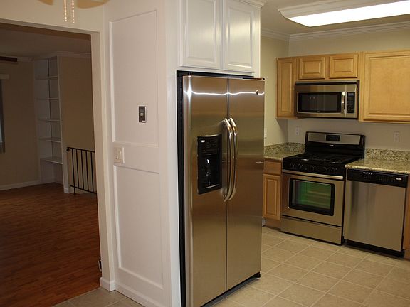New stainless steel 25+ cubic foot GE refrigerator with custom cabinet.