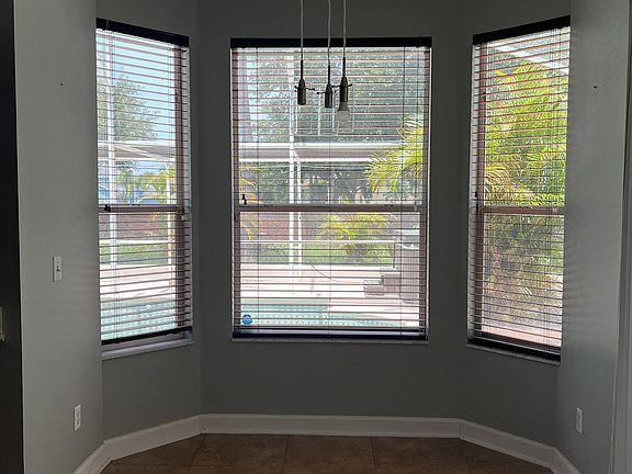 Breakfast nook in kitchen onlooking to the pool and patio