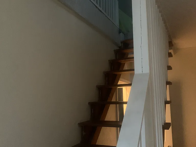 Stairway to third floor bedroom and deck