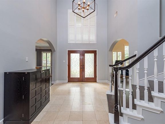Travertine floors welcome you into this lovely home.