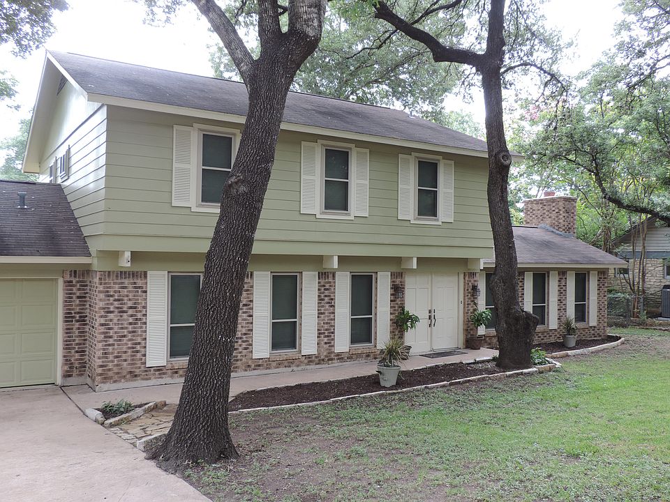 Entry with tall mature trees