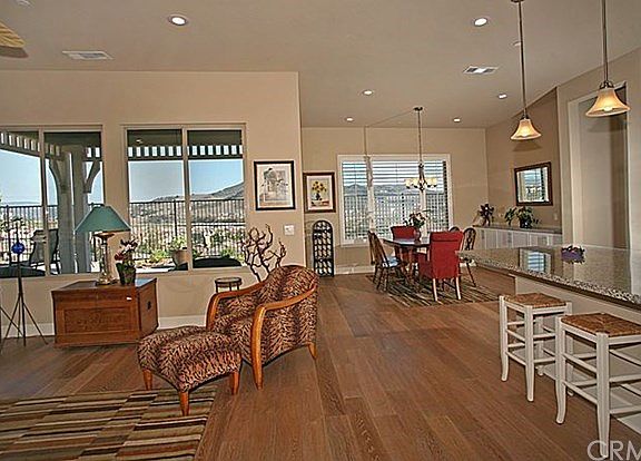 Great Room with views at every turn. Notice the hand scraped, distressed floors which run throughout the home.