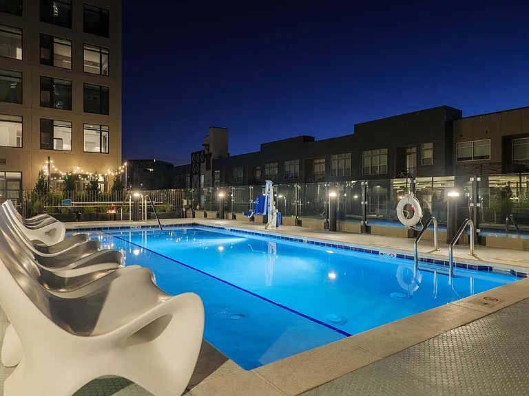 Relax by the pool under the night sky, with ambient lighting setting the perfect mood.
