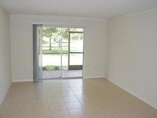 Open floor plan with tile and carpet and crown molding