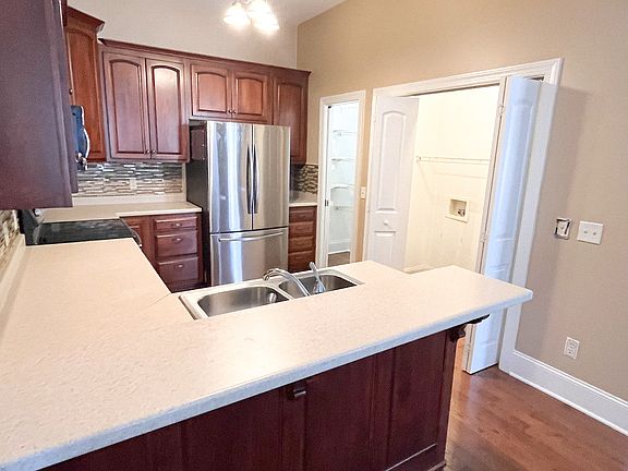 Kitchen with washer and dryer hookups.