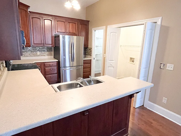 Kitchen with washer and dryer hookups.