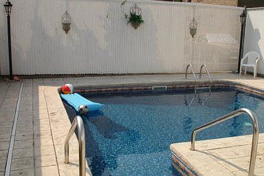 15x18 inground heated pool surrounded by Bomamite custom concrete