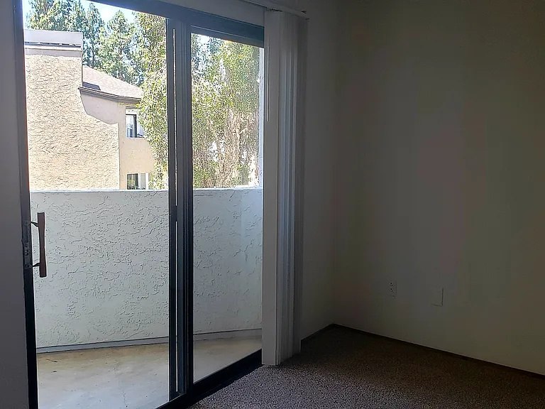 Bedroom with sliding door to balcony