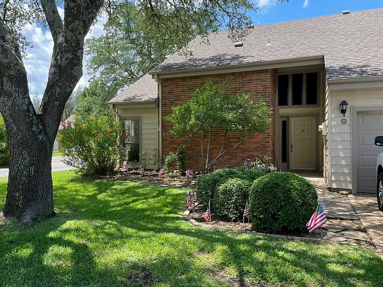 Mature landscaping makes a beautiful entrance.