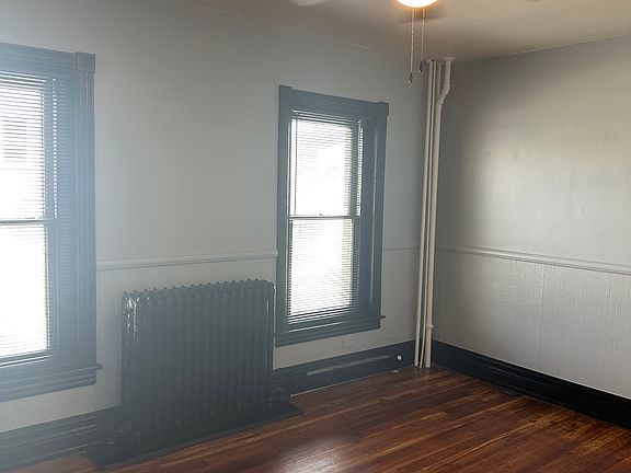 Living room with ceiling fan and hardwood floors