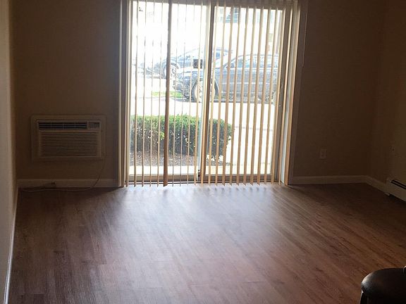 large living room with sliders to patio and ceiling fan