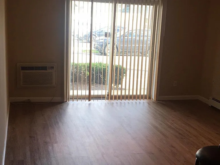 large living room with sliders to patio and ceiling fan