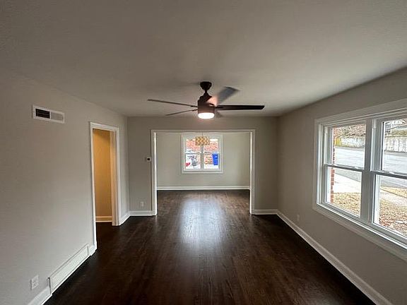 Large Living room with hardwood floors, new windows and ceiling fan