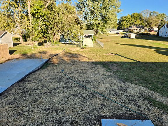 Property goes back to the fence. To the left on the concrete pad, a garage will be installed.