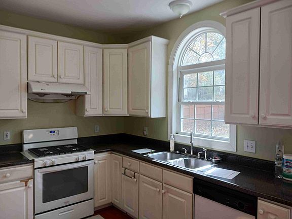 Kitchen appliances include gas range, dishwasher, refrigerator. Refrigerator is left as a convenience.