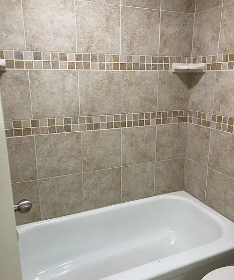 Indulge in the elegance of this chic bathroom, designed with stylish tiled walls. Indulge in the elegance of this chic bathroom, designed with stylish tiled walls.