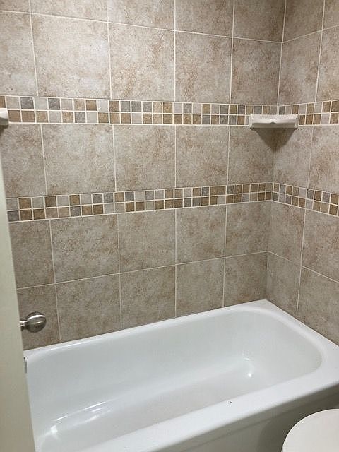 Indulge in the elegance of this chic bathroom, designed with stylish tiled walls. Indulge in the elegance of this chic bathroom, designed with stylish tiled walls.