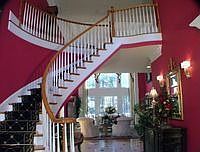 Dramatic two story entry foyer with curved staircase. 