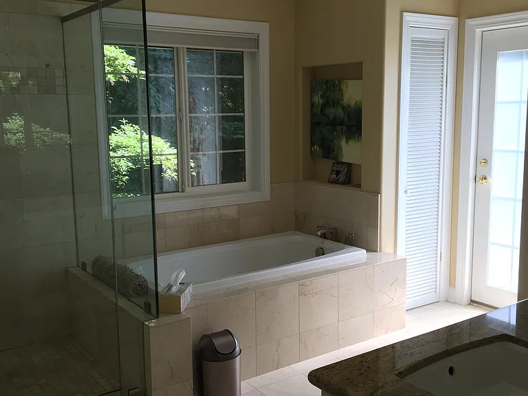 Jetted whirlpool, heated radiant floor. Linen closet. Exterior Patio door that leads to a private patio.