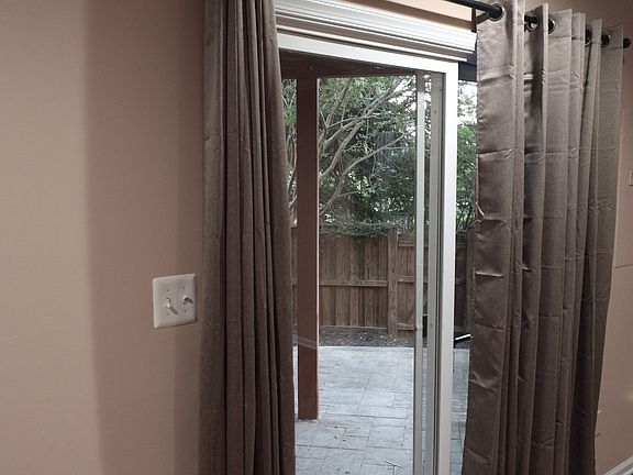 Fenced backyard with stone patio