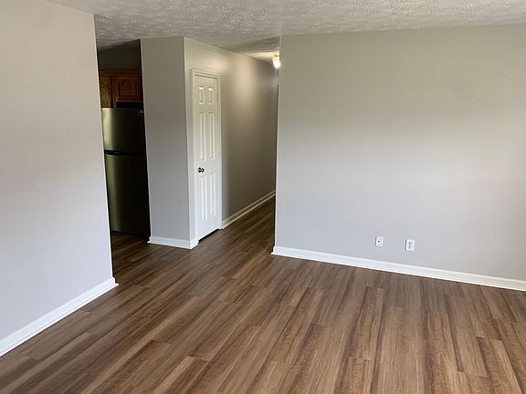 living area with entrance to kitchen and hallway, extra hall closet for storage