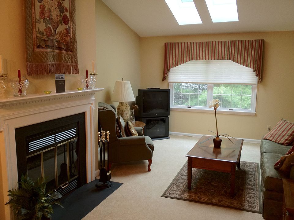 Open area living room with fireplace & large TV