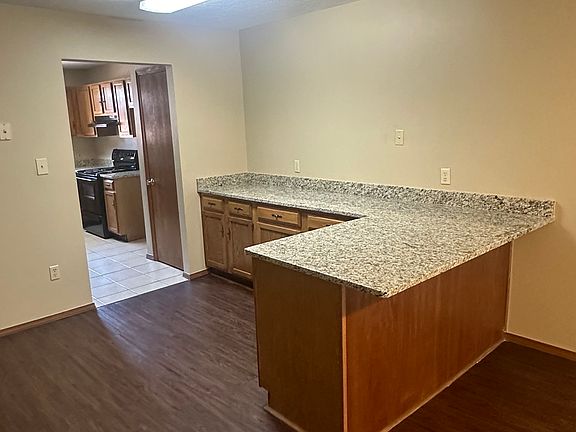 Dinning area with bar granite countertops and plenty of cabinets underneath