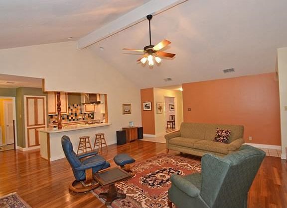 Spacious Family Room with Wood Floors and Vaulted Beam Ceiling