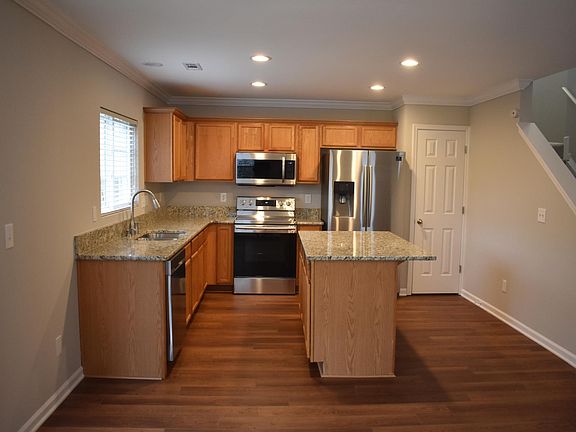 Large kitchen overlooks fenced back yard