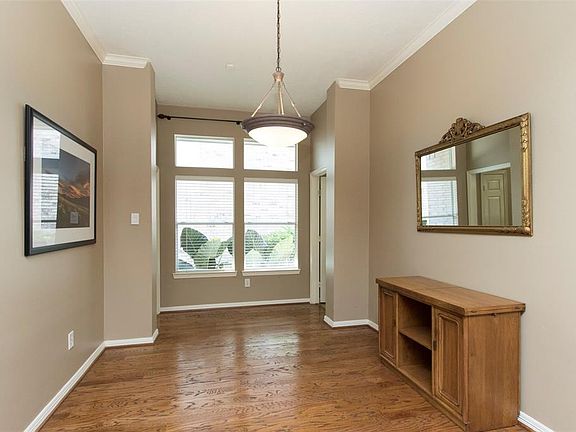 Formal dining room boasts double windows, crown molding, hardwoods and high ceilings.