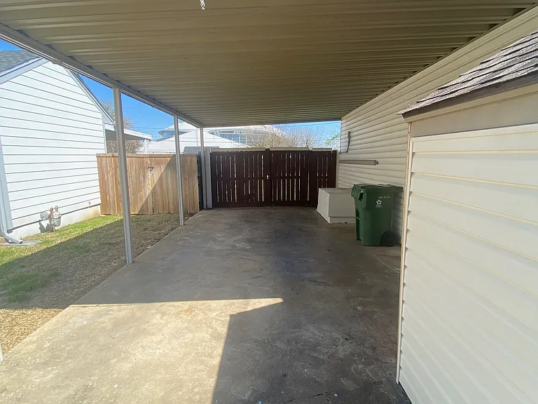 covered parking on side of home. enough room for two cars, stacked.