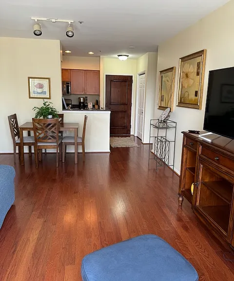 Looking from balcony toward front door entrance. Bright, open floor plan.
