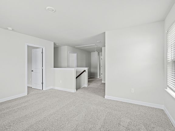 The stairs lead to a second floor with flexible work area.