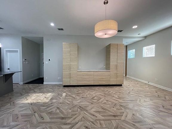 Spare room with baseboards and recessed lighting