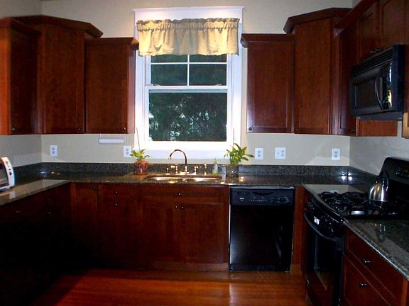 Updated kitchen with granite and cherry cabinets