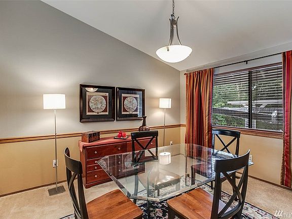 The dining room also features a vaulted ceiling, updated lighting and lovely mill-work.